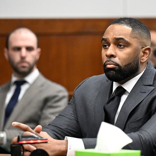 Former Michigan football coach Sherrone Moore, center, appears in the courtroom, Thursday, Jan. 22, 2026, in Ann Arbor, Mich. (AP Photo/Jose Juarez)