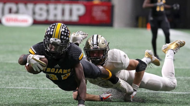 Noah Whittington tackled by Calhoun's Brannon Spector at the end of the Calhoun/Peach County Class AAA title game. Photo: Jason Getz, AJC