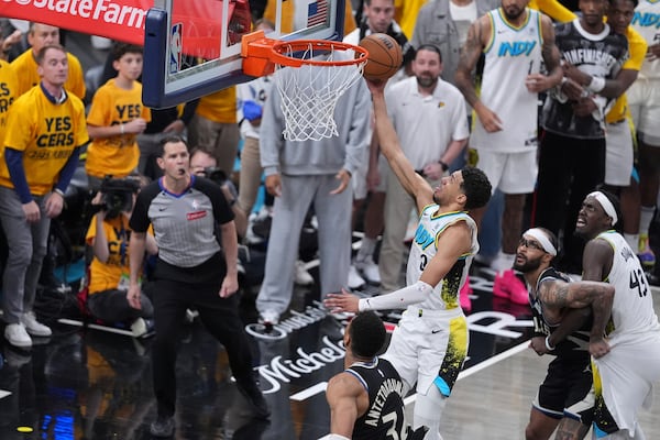 Indiana Pacers guard Tyrese Haliburton (0) shoots the game winning basket over Milwaukee Bucks forward Giannis Antetokounmpo, left, and guard Gary Trent Jr., right, during overtime in Game 5 of an NBA basketball first-round playoff series in Indianapolis, Tuesday, April 29, 2025. (AP Photo/Michael Conroy)