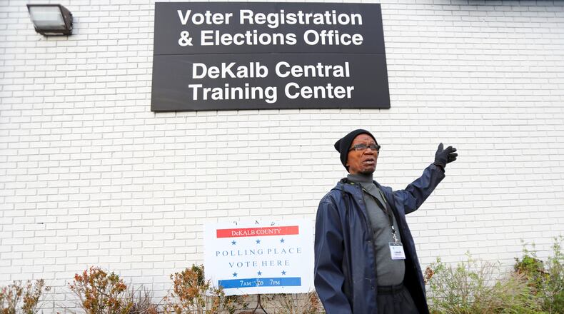 Andrew Walker, election logistics worker in Dekalb County, puts the last signs around the Voter Registration and Elections Office in Atlanta on Monday, March 2, 2020.