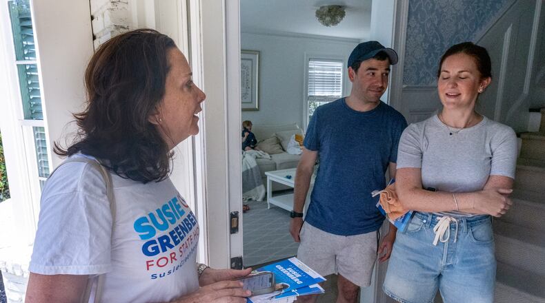 Democratic state House candidate Susie Greenberg, shown talking to homeowners Catherine and Brad Cohen as she canvasses a Sandy Springs neighborhood Saturday, said switching in Vice President Kamala Harris has boosted enthusiasm within the party. "The energy is palpable," she said. (Steve Schaefer / AJC)