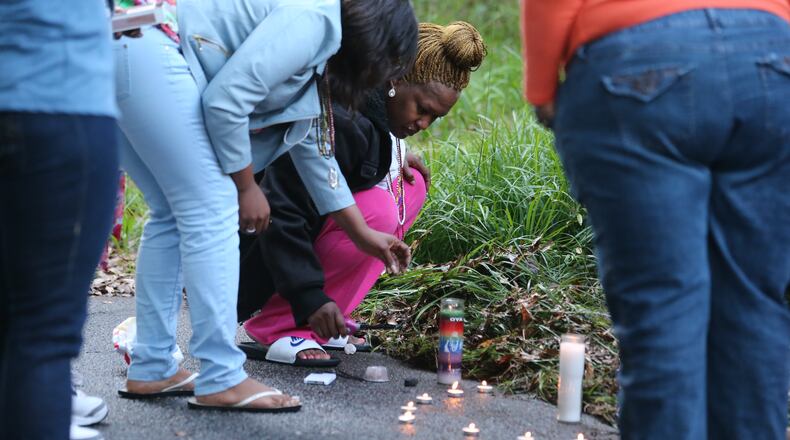 Atlanta police this morning were investigating a predawn shooting that left a man dead in the middle of a southwest Atlanta street. Family members grieve by a makeshift memorial. The shooting happened around 3:15 a.m. in the 1800 block of Orlando Street, according to Atlanta police Capt. Paul Guerrucci. JOHN SPINK/JSPINK@AJC.COM