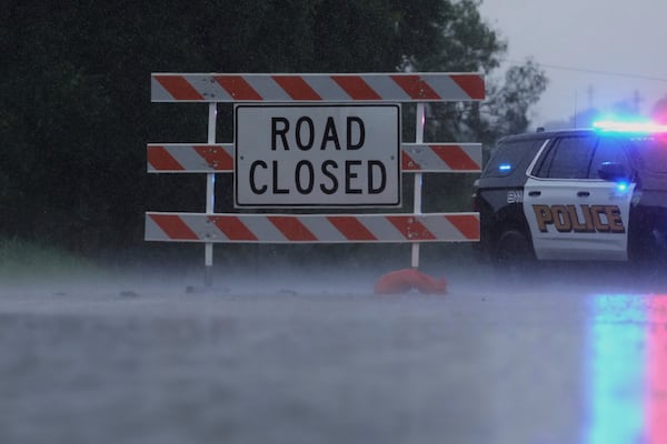A barricade blocks a road during heavy rains, Sunday, July 13, 2025, in Kerrville, Texas. (AP Photo/Eric Gay)