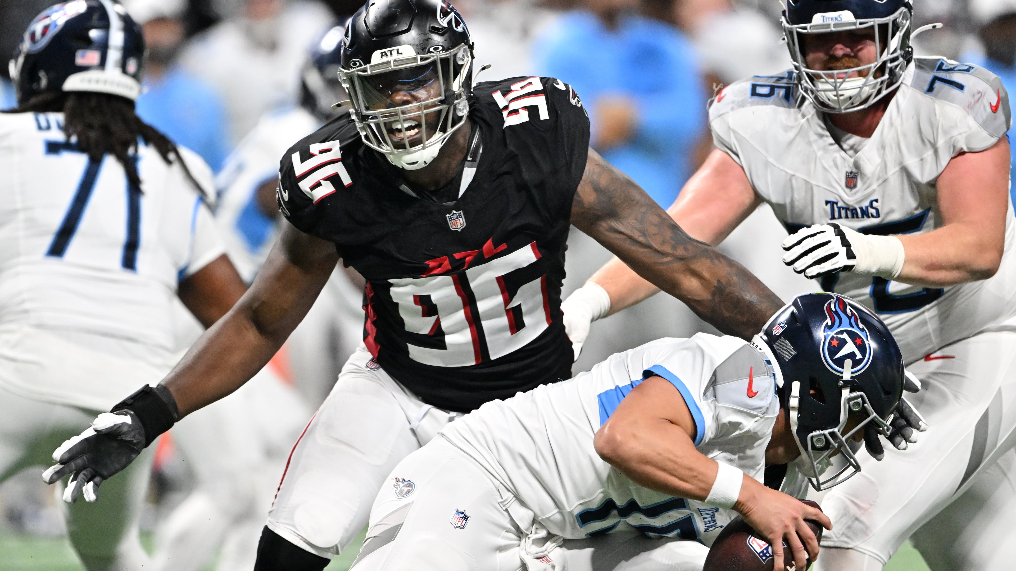 Falcons defensive end Zach Harrison — pictured pressuring Titans quarterback Trevor Siemian (bottom) in an exhibition game in August — leads Atlanta with 2.5 sacks this season. (Hyosub Shin/AJC)