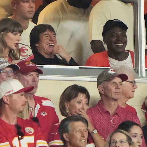 Taylor Swift, left, sits with Tom Cruise, center, while watching the first half of an NFL football game between the Kansas City Chiefs and the Denver Broncos, Monday, Sept. 14, 2026, in Kansas City, Mo. (AP Photo/Charlie Riedel)
