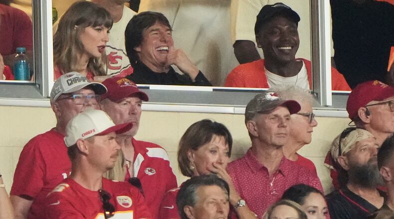 Taylor Swift, left, sits with Tom Cruise, center, while watching the first half of an NFL football game between the Kansas City Chiefs and the Denver Broncos, Monday, Sept. 14, 2026, in Kansas City, Mo. (AP Photo/Charlie Riedel)