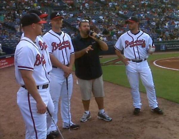 Mark Owens (second from right) serves as in-game host for the "Closest to the Pin" contest in 2010 with Braves players (from left) Brooks Conrad, Peter Moylan, David Ross and Billy Wagner. (Courtesy)