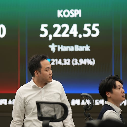 Dealers work near the screens showing the Korea Composite Stock Price Index (KOSPI), right, and the foreign exchange rate between U.S. dollar and South Korean won at a dealing room of Hana Bank in Seoul, South Korea, Monday, March 30, 2026. (AP Photo/Lee Jin-man)