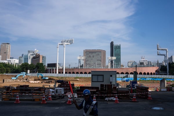 Workers at a construction site near the Jingu stadium in Tokyo, Monday, June 30, 2025. (AP Photo/Louise Delmotte)