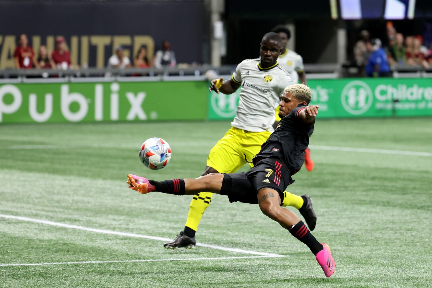Atlanta United forward Josef Martinez (7) attempts a shot against Columbus Crew defender Jonathan Mensah (4). JASON GETZ FOR THE ATLANTA JOURNAL-CONSTITUTION