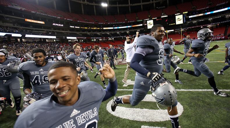 Norcross players run onto the field as time expires to begin the celebration of their state championship.