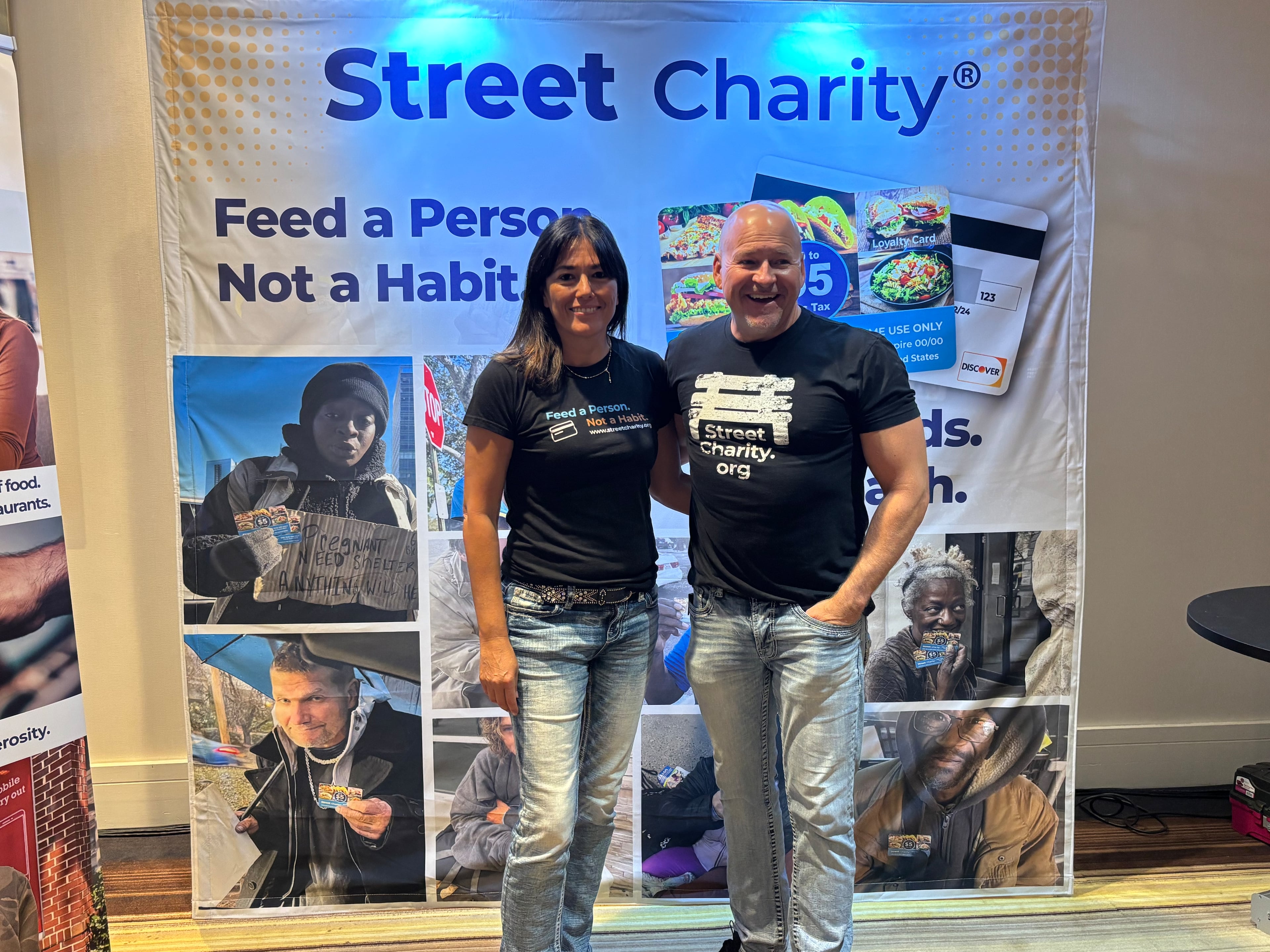 Street Charity co-founders Antuanette Patton (left) and John Patton stand at their booth at the QSR Evolution Conference on Sept. 2, 2025, at the Atlanta Marriott Marquis. (Courtesy of Jonathan Olens)