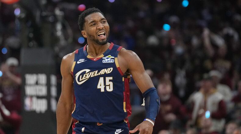 Cleveland Cavaliers guard Donovan Mitchell (45) gestures to the crowd in the first half in Game 2 of a first-round NBA basketball playoffs series against the Toronto Raptors in Cleveland, Monday, April 20, 2026. (AP Photo/Sue Ogrocki)