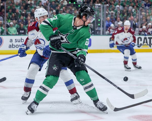 Dallas Stars left wing Mason Marchment (27) and Colorado Avalanche defenseman Ryan Lindgren (55) battle for control of the puck during the first period of Game 5 of a first-round NHL hockey playoff series in Dallas, Monday, April 28, 2025. (AP Photo/Gareth Patterson)