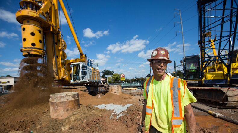 A construction worker stands where a future performing arts center will be built as part of the new City Center off of Roswell Road, Monday, Oct. 12, 2015, in Sandy Springs. BRANDEN CAMP / For the AJC