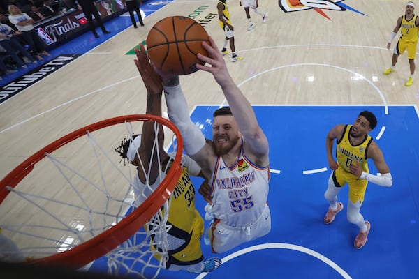 Oklahoma City Thunder center Isaiah Hartenstein (55) dunks over Indiana Pacers center Myles Turner (33) during the second half of Game 5 of the NBA Finals basketball series, Monday, June 16, 2025, in Indianapolis. (Matthew Stockman/Pool Photo via AP)