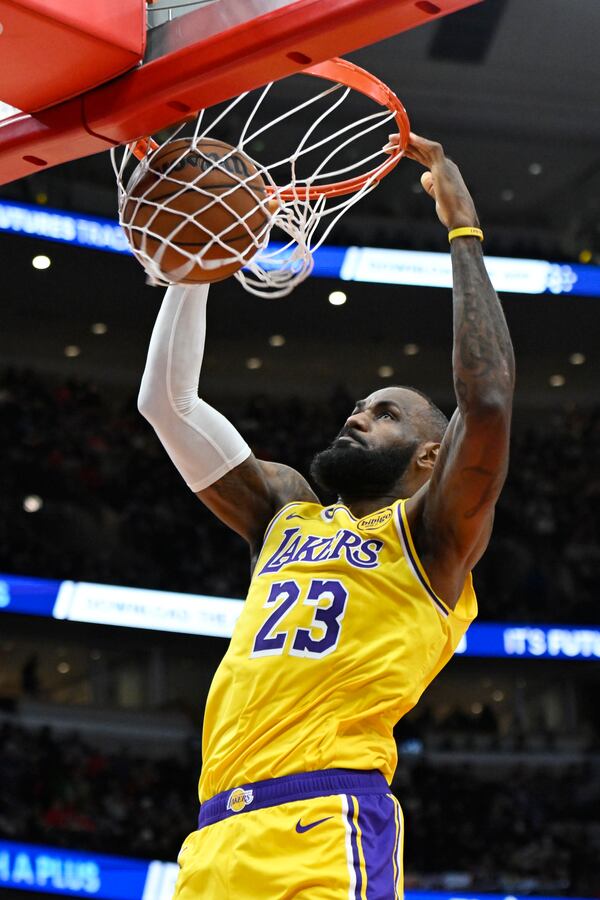 Los Angeles Lakers' LeBron James dunks during the first half of an NBA basketball game against the Chicago Bulls Thursday, March 27, 2025, in Chicago. (AP Photo/Paul Beaty)