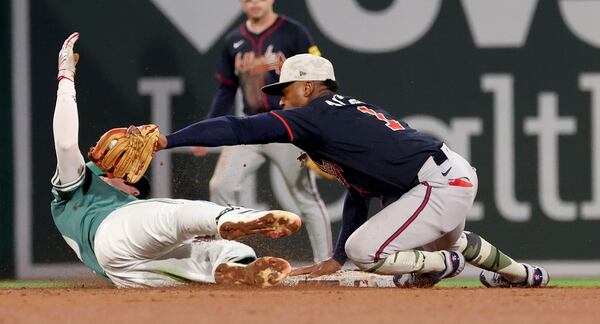 Atlanta Braves second baseman Ozzie Albies, right, tags out Boston Red Sox's Nick Sogard, left, during the seventh inning of a baseball game Friday, May 16, 2025, in Boston. (AP Photo/Mark Stockwell)