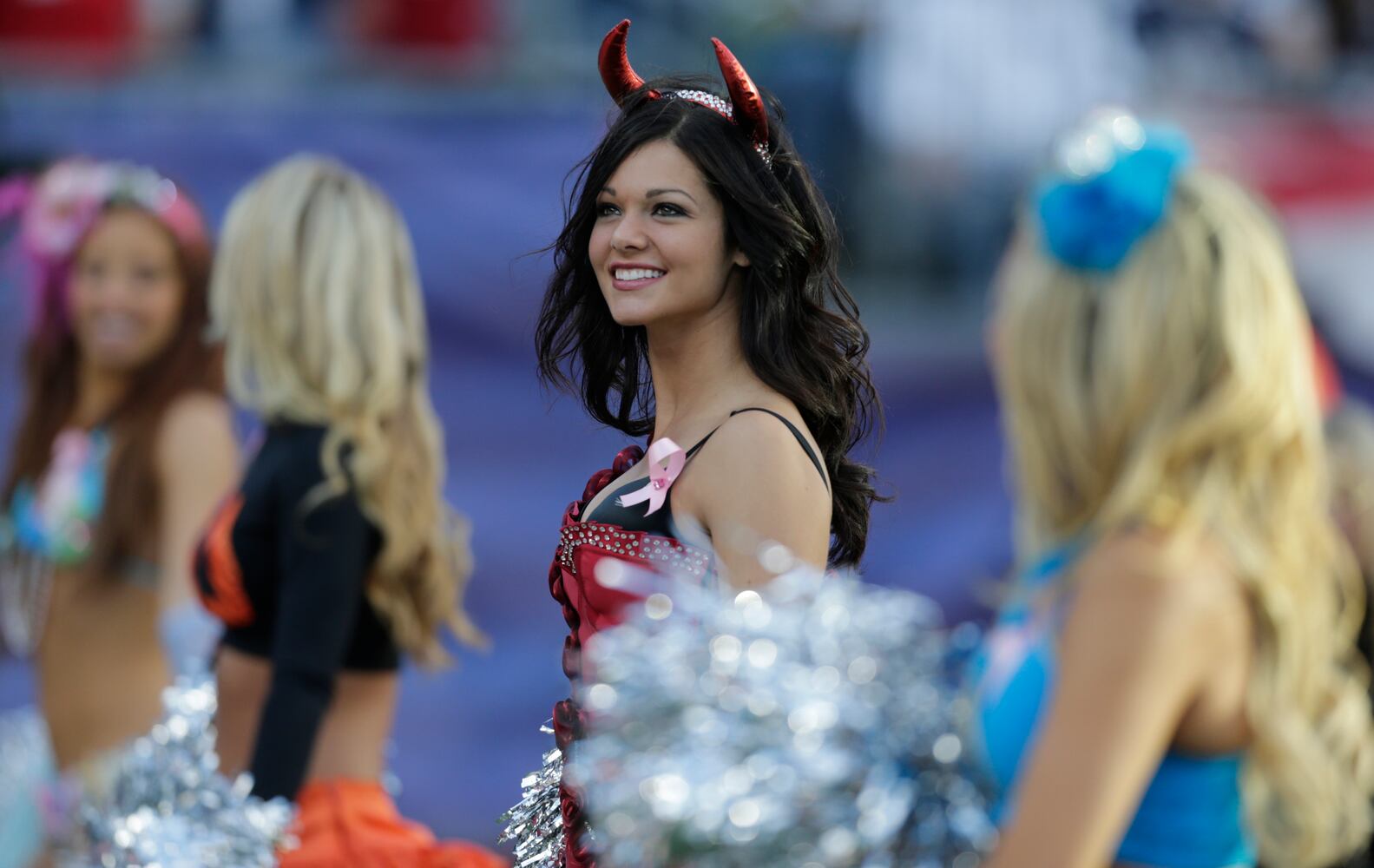 Cheerleaders take to the field in costumes