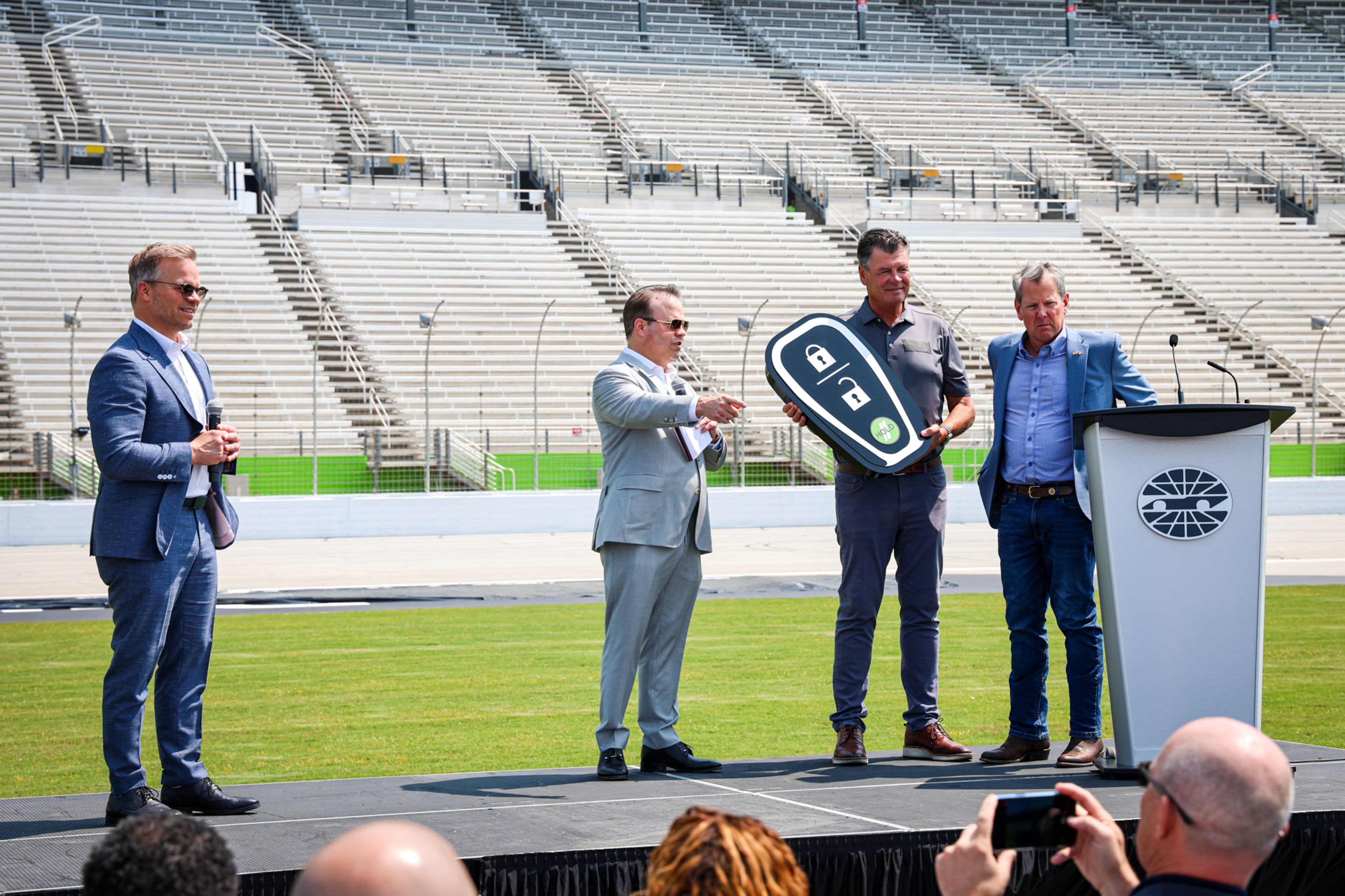 From left: Marcus Smith, president and CEO of Speedway Motorsports; David B. Smith, chairman and CEO of Sonic Automotive; Michael Waltrip, a former NASCAR driver who is a two-time Daytona 500 champion; and Georgia Gov. Brian Kemp. (Courtesy of EchoPark Speedway)