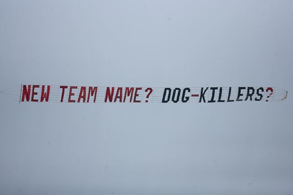  070726 FLOWERY BRANCH, GA.: --A plane pulls a banner in the air over the field as the Atlanta Falcons practice during their first day of training camp in Flowery Branch on Thursday, July 26, 2007. (PHOTO BY CURTIS COMPTON/staff)