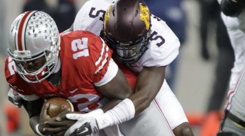 Minnesota defensive back Jalen Myrick tackling Ohio State quarterback Cardale Jones. (Associated Press)
