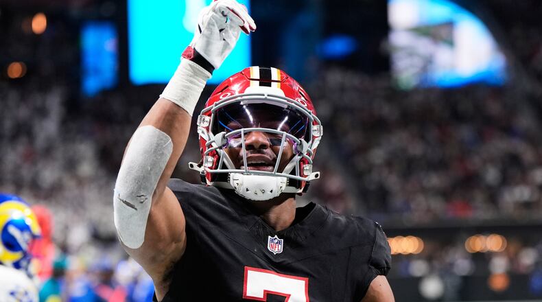 FILE - Atlanta Falcons running back Bijan Robinson (7) celebrates his touchdown reception against the Los Angeles Rams in the first half of an NFL football game, Dec. 29, 2025, in Atlanta. (AP Photo/Brynn Anderson, File)