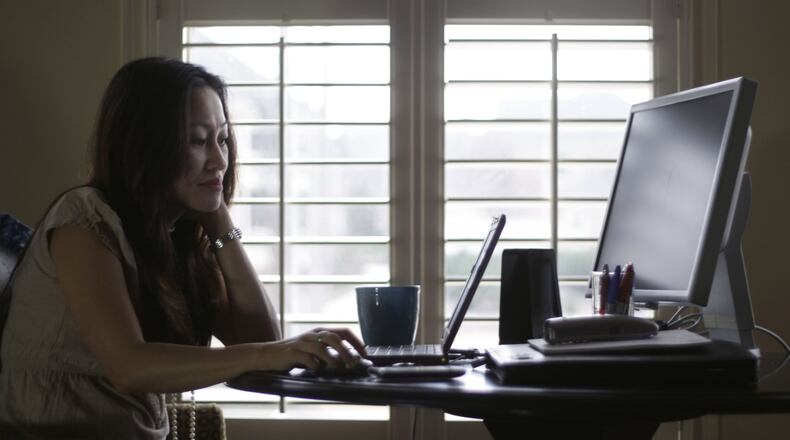 Denise Kenson-Liu (shown here in a 2011 photo) has been teleworking since about 2007, but experts say that in the wake of the coronavirus, this could become our new normal. BOB ANDRES / BANDRES@AJC.COM