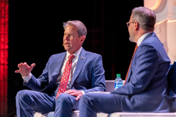 Gov. Brian Kemp speaks with Chamber of Commerce President Chris Clark at the chamber’s annual Eggs and Issues breakfast in Atlanta on Wednesday, January 11, 2023. (Arvin Temkar / arvin.temkar@ajc.com)