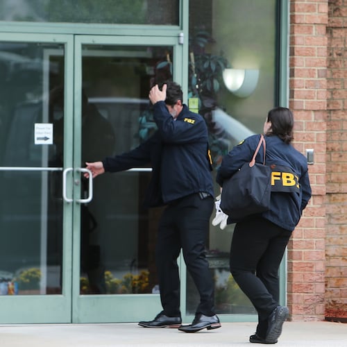 FBI personnel enter a building in Portsmouth, Va., Wednesday, May 6, 2026. (AP Photo/John Clark)