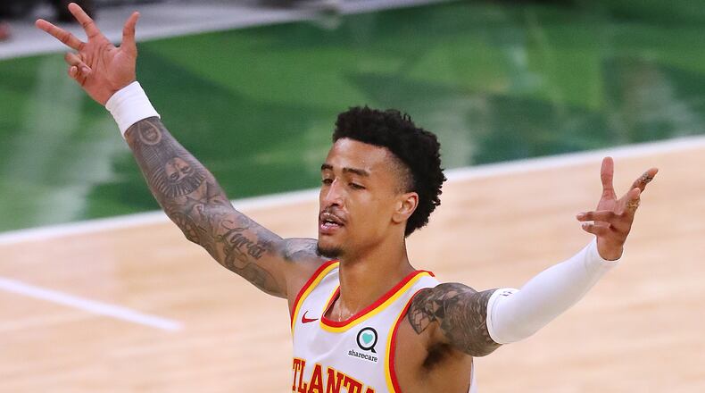Hawks forward John Collins reacts as Trae Young hits a three-pointer.   “Curtis Compton / Curtis.Compton@ajc.com”