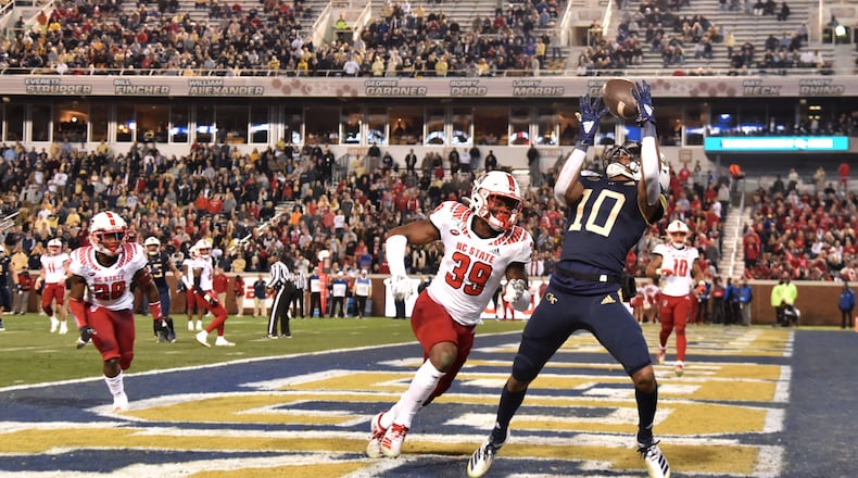 Georgia Tech wide receiver Ahmarean Brown (10) makes a touchdown catch over North Carolina State defensive back Jakeen Harris (39) during the first half of an NCAA college football game at Bobby Dodd Stadium on Thursday, November 21, 2019. (Hyosub Shin / Hyosub.Shin@ajc.com)