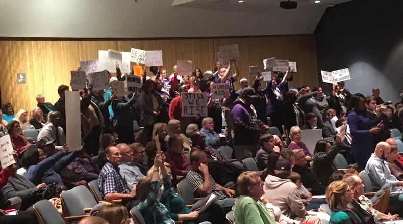 Dozens of protesters turned out again Tuesday night to protest Gwinnett County Commissioner Tommy Hunter, who recently called civil rights leader and U.S. Rep. John Lewis a "racist pig" on Facebook.