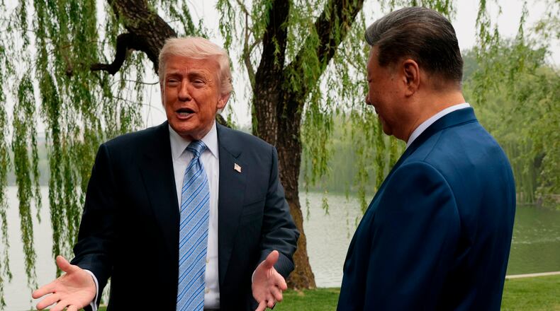 U.S. President Donald Trump, left, speaks as he is greeted by Chinese President Xi Jinping at Zhongnanhai Garden in Beijing, China, Friday, May 15, 2026. (Evan Vucci/Pool Photo via AP)