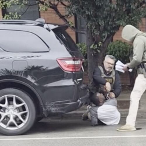 This image taken from video shows a federal officer removing handcuffs from a U.S. citizen after immigration enforcement agents mistook him for a fugitive, Sunday, Sept. 20, 2026, in Evanston, Ill. (Michael Lipson via AP)