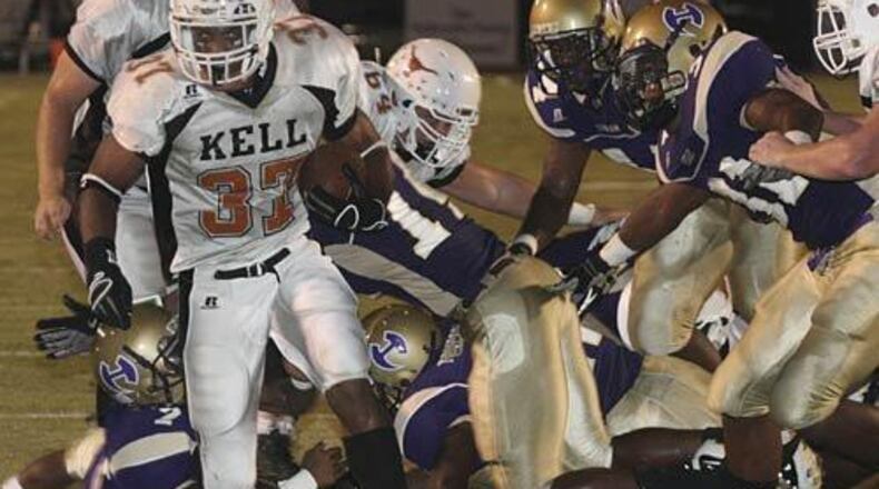 Kell RB Brian Randolph (37) breaks through Hiram's defense for a touchdown in the first quarter. (AJC file photo)