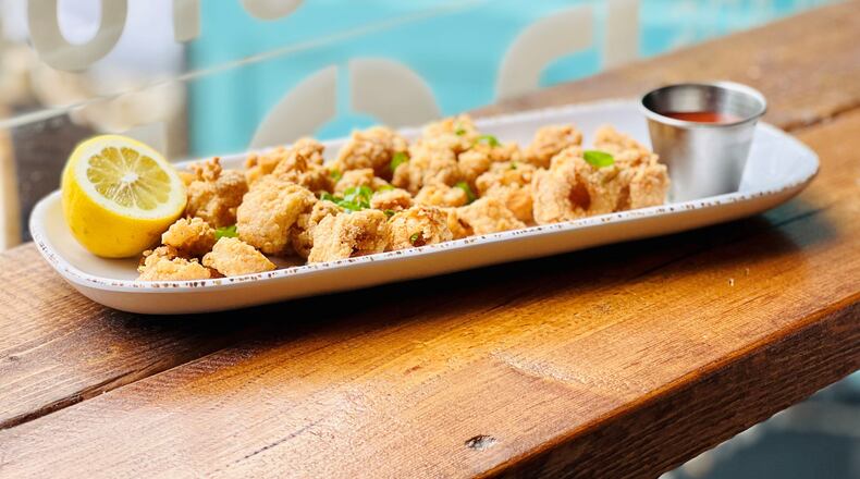 An order of fried calamari brings shatteringly crisp squid deliciously seasoned with extra shakes of black pepper, served with a kicked up remoulade. Photo by Liane St. Clair