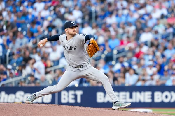 New York Yankees pitcher Clarke Schmidt throws against the Toronto Blue Jays during first-inning baseball game action in Toronto, Thursday, July 3, 2025. (Thomas Skrlj/The Canadian Press via AP)