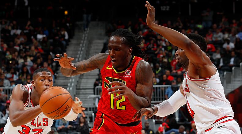 Kris Dunn of the Chicago Bulls attempts a steal as Taurean Prince of the Atlanta Hawks drives against David Nwaba at Philips Arena on March 11, 2018 in Atlanta, Georgia. (Photo by Kevin C. Cox/Getty Images)