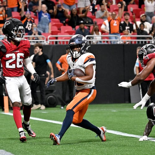 Broncos running back Jaleel McLaughlin (center) scores a touchdown against the Falcons during their exhibition game at Mercedes-Benz Stadium on Friday, Aug. 14, 2026, in Atlanta. By halftime, the Broncos had run 17 times for 94 yards. (Hyosub Shin/AJC)