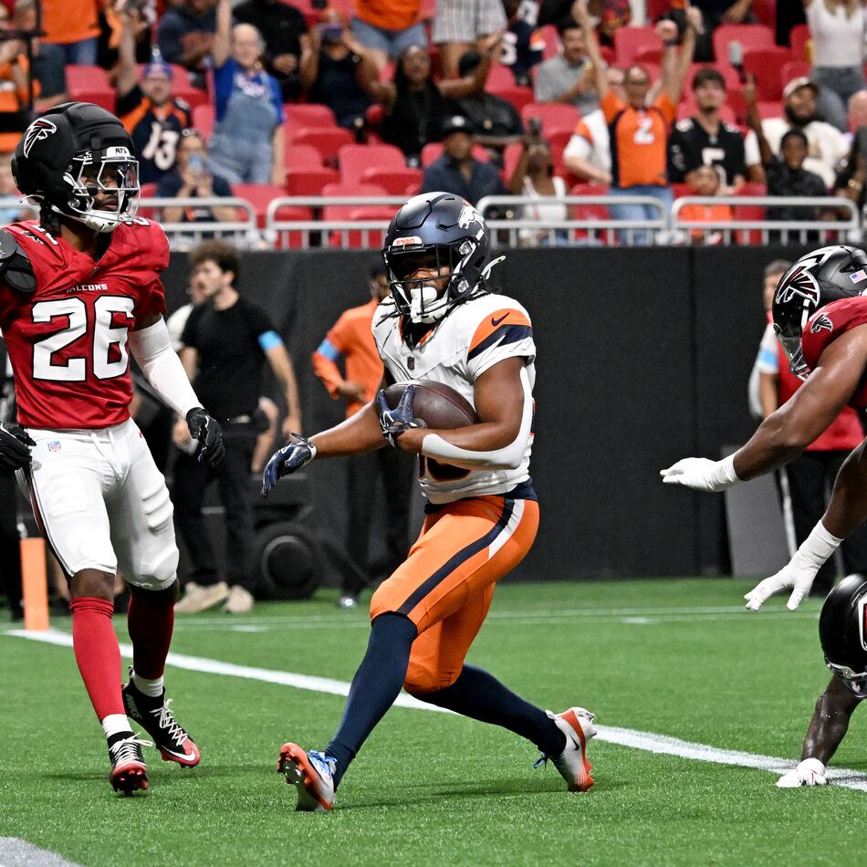 Broncos running back Jaleel McLaughlin (center) scores a touchdown against the Falcons during their exhibition game at Mercedes-Benz Stadium on Friday, Aug. 14, 2026, in Atlanta. By halftime, the Broncos had run 17 times for 94 yards. (Hyosub Shin/AJC)