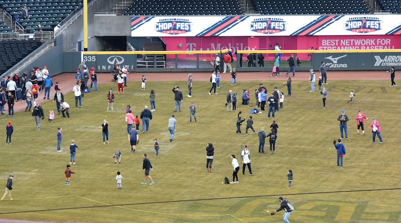 Fans take part in on-field activities in wet weather during Atlanta Braves 2019 Chop Fest Saturday, Jan. 19, 2019, at SunTrust Park