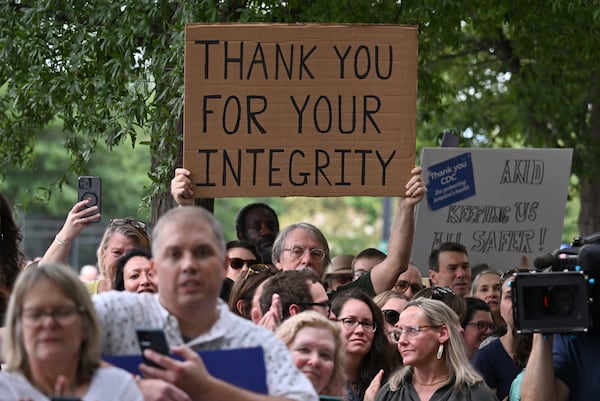 Centers for Disease Control and Prevention staff and supporters hold signs as they gather to rally for departing leaders Debra Houry, Demetre Daskalakis and Daniel Jernigan outside the CDC headquarters, Thursday, August 28, 2025, in Atlanta. The top leaders, who resigned their positions at the CDC after the ouster of the agency’s director, were escorted out of the building Thursday morning. (Hyosub Shin/AJC)
