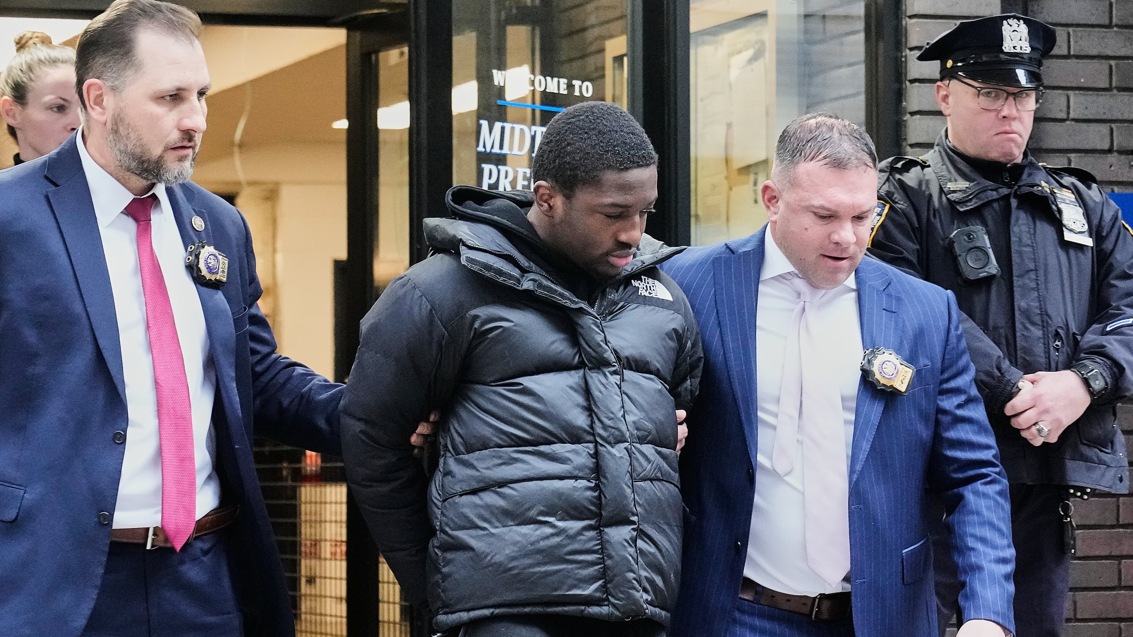 Frederick Green, 20, of The Bronx borough of New York, charged with attempted murder in the shooting of New York Jets' player Kris Boyd, is escorted from the Midtown South Police Precinct, in New York, Tuesday, Dec. 9, 2025. (AP Photo/Richard Drew)