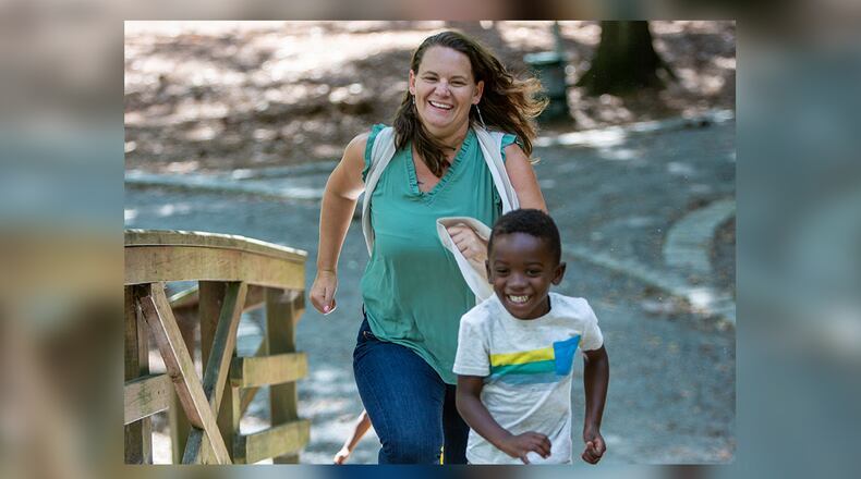 Single foster mom and adoptive mom, Amanda Vandalen, races Jeremiah, age 4, during an outing at Lake Avondale in Avondale Estates. She is also a social worker with the Gateway Center, a transitional shelter for the homeless on Prior Street in Atlanta. (Photo by Phil Skinner)
