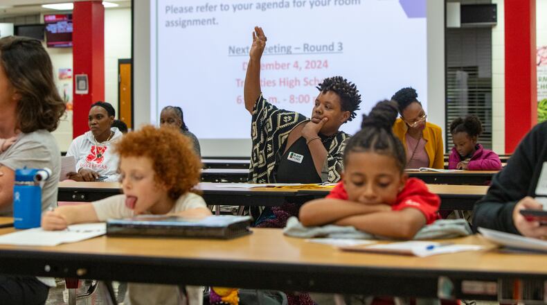 Concerned South Fulton parents, including Shaunda Freeman, center, ask questions of the school district’s staff at Tri-Cities High School on Wednesday, Nov 6, 2024 about a proposal to close Parklane Elementary School in East Point. The Fulton County school board voted Thursday to 5-2 to advance a plan to close Parklane. (Jenni Girtman for The Atlanta Journal-Constitution)