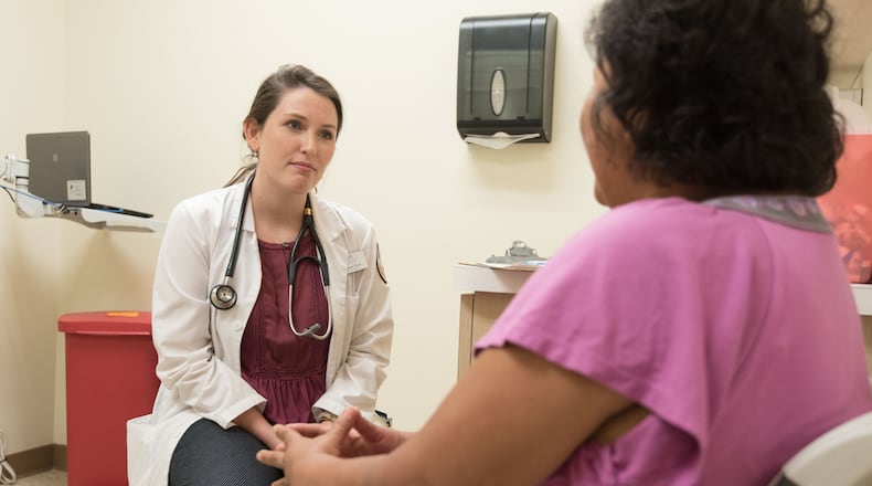 A Good Samaritan Health Centers of Gwinnett provider consults with a patient. COURTESY GOOD SAM GWINNETT