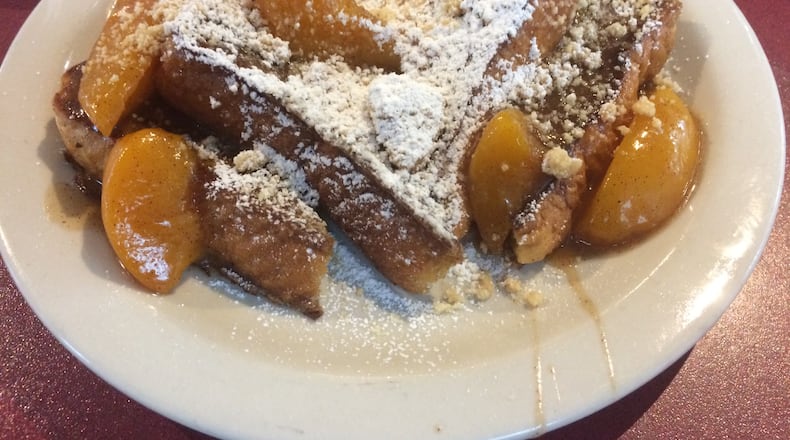 The peach cobbler French toast at Atlanta Breakfast Club is made with two of Georgia's most famous ingredients: peaches are cooked in a brown-butter sauce with a shot of Coca-Cola. PHOTO CREDIT: Wendell Brock