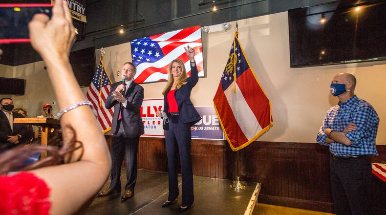 Senators David Perdue, left, Kelly Loeffler, center, and Florida Senator Rick Scott, right, joined together for a rally on Friday, November 13, 2020 at Black Diamond Grill in Cumming, GA.  Both Georgia candidates head to a run-off election in January.  (Jenni Girtman for The Atlanta Journal Constitution)