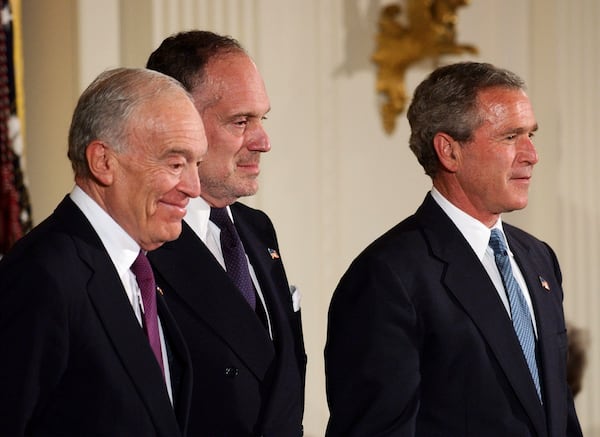 FILE- Leonard Lauder, left, and Ronald Lauder, sons of the late cosmetics mogul Estee Lauder, stand next to President Bush as they receive the Presidential Medal of Freedom on her behalf, which was awarded posthumously to her during a ceremony in the East Room of the White House in Washington Wednesday, June 23, 2004. (AP Photo/Gerald Herbert, file)